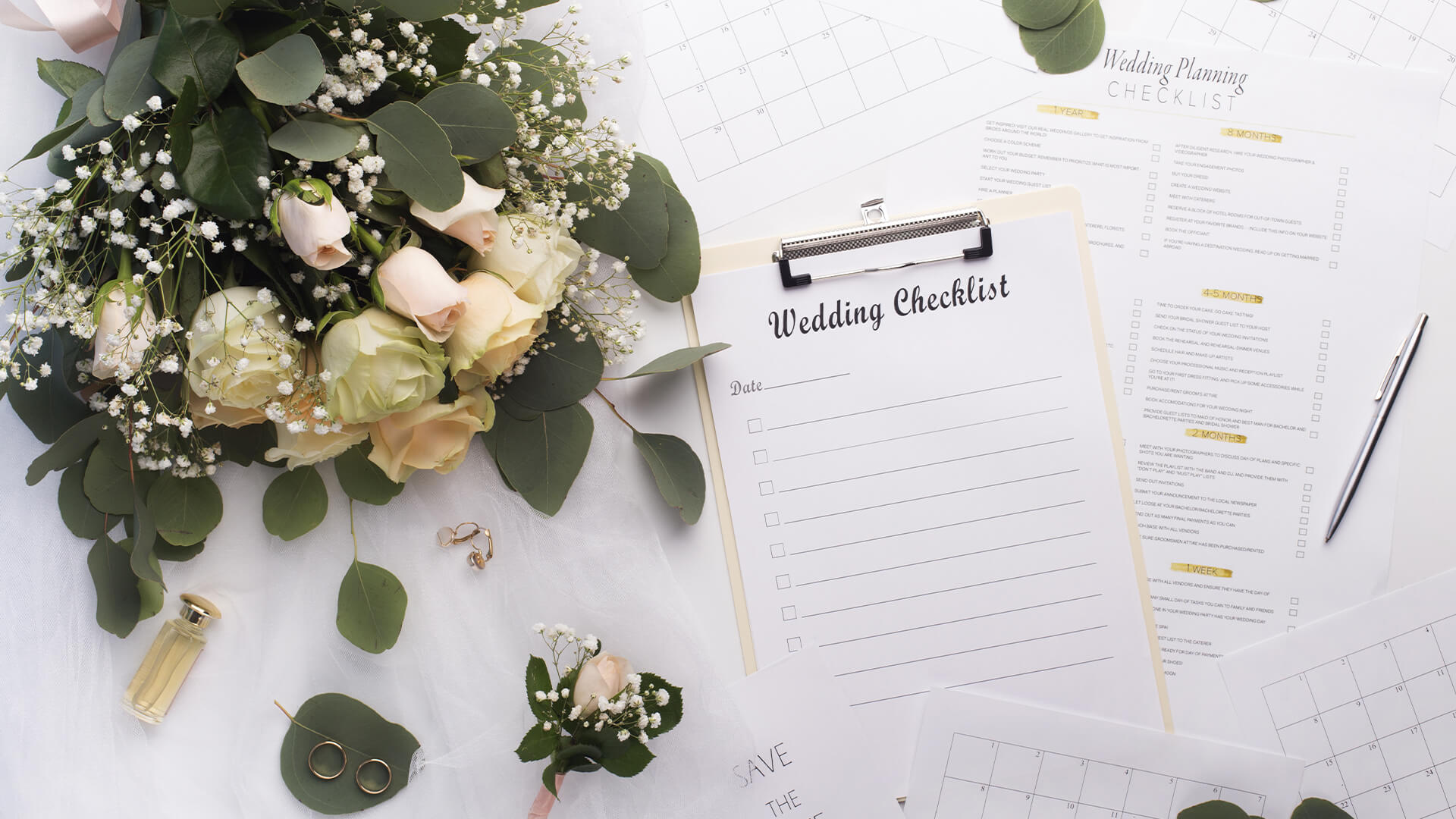 Bouquet of white and pink roses with a wedding checklist on a clipboard
