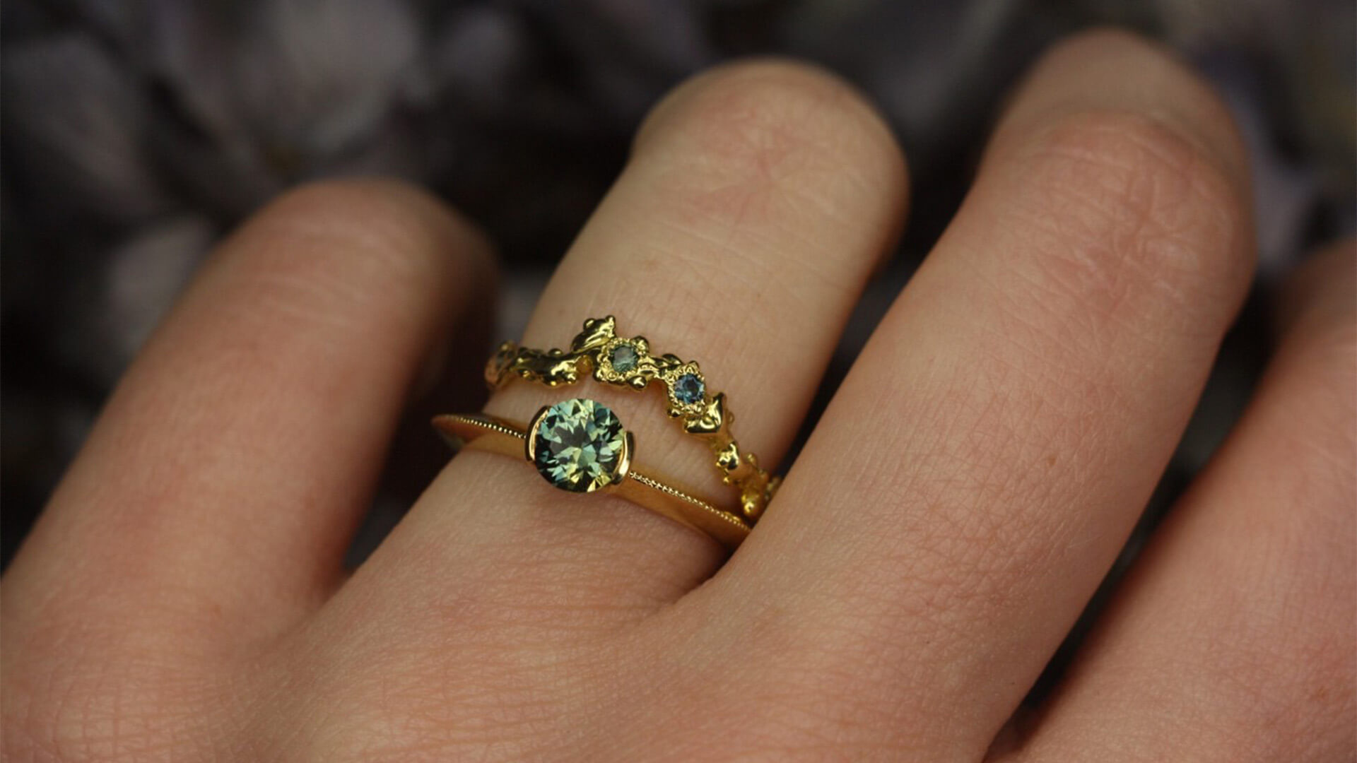 A close up of a weedding and engagment ring on a ring finger