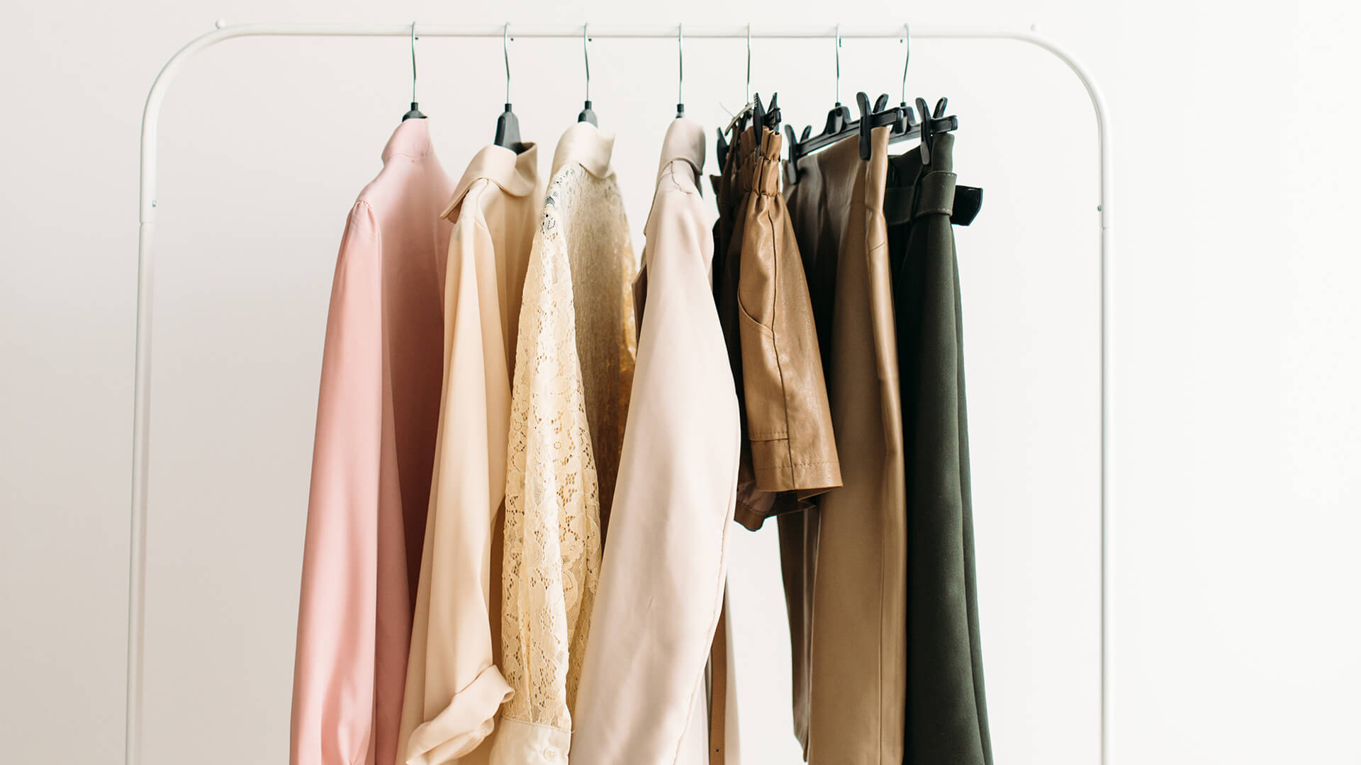 Capsule wardrobe style clothes on a rack