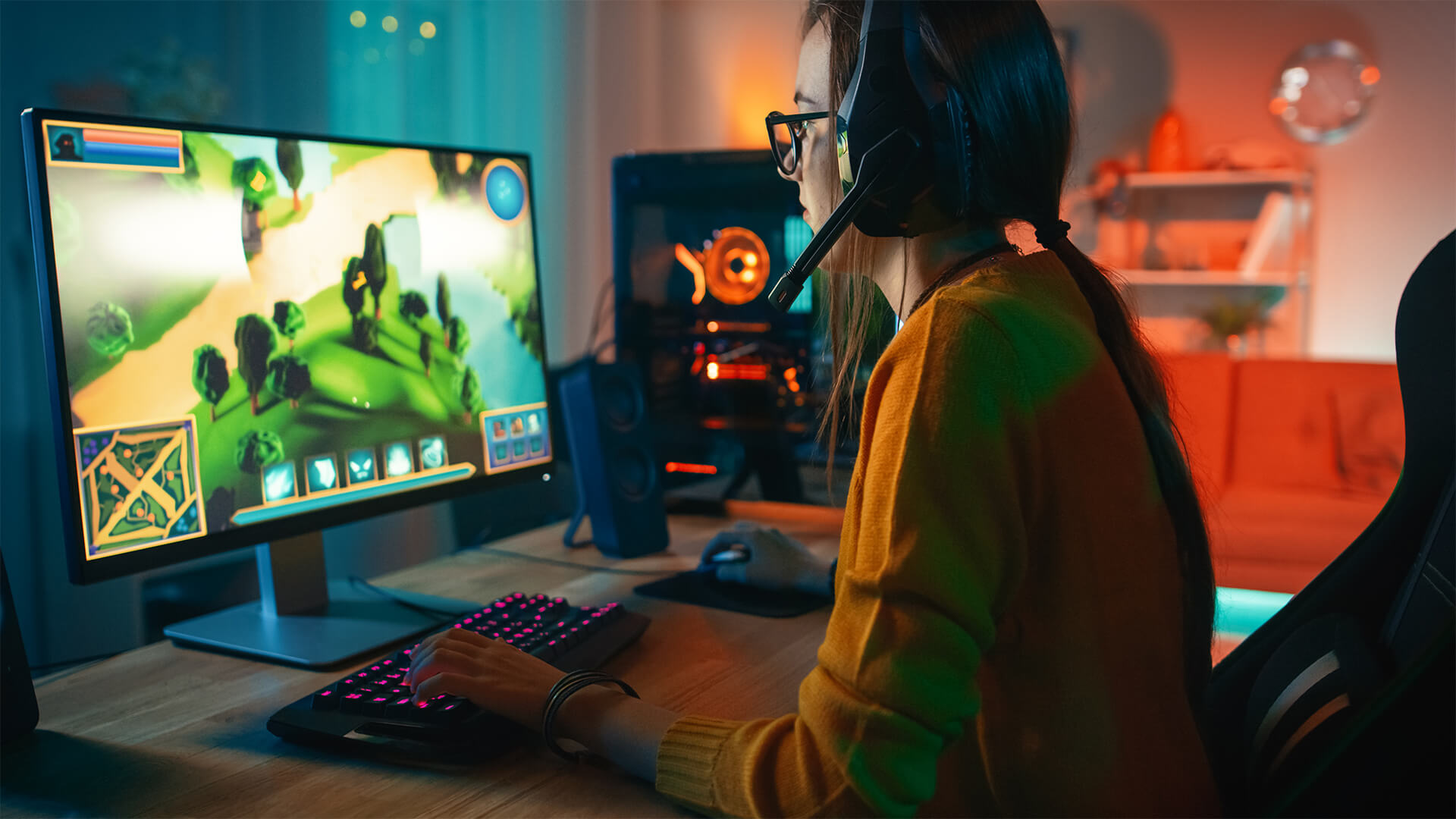 Girl sat infront of gaming pc with headset