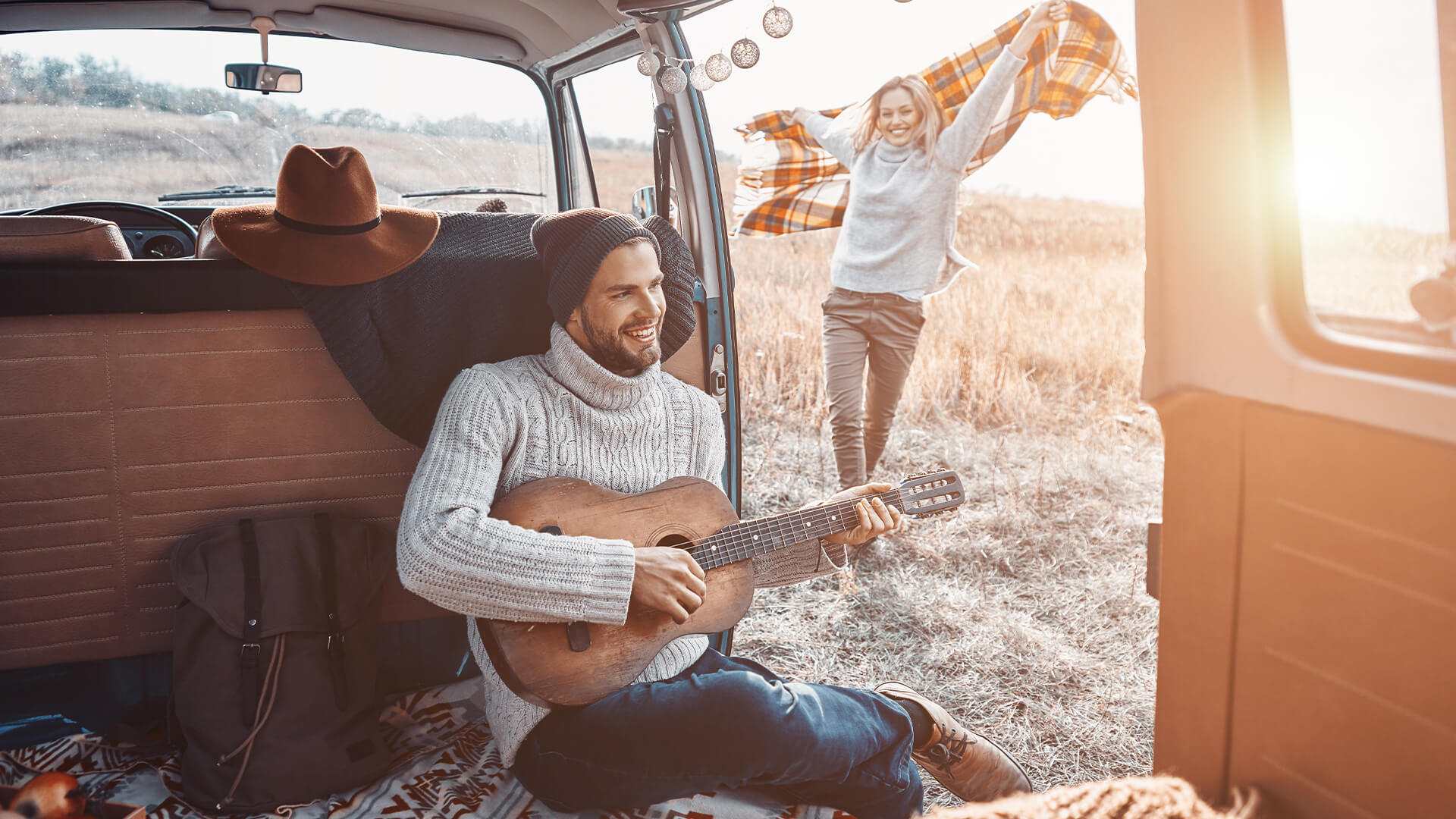 Man Playing Guitar in Travel Van