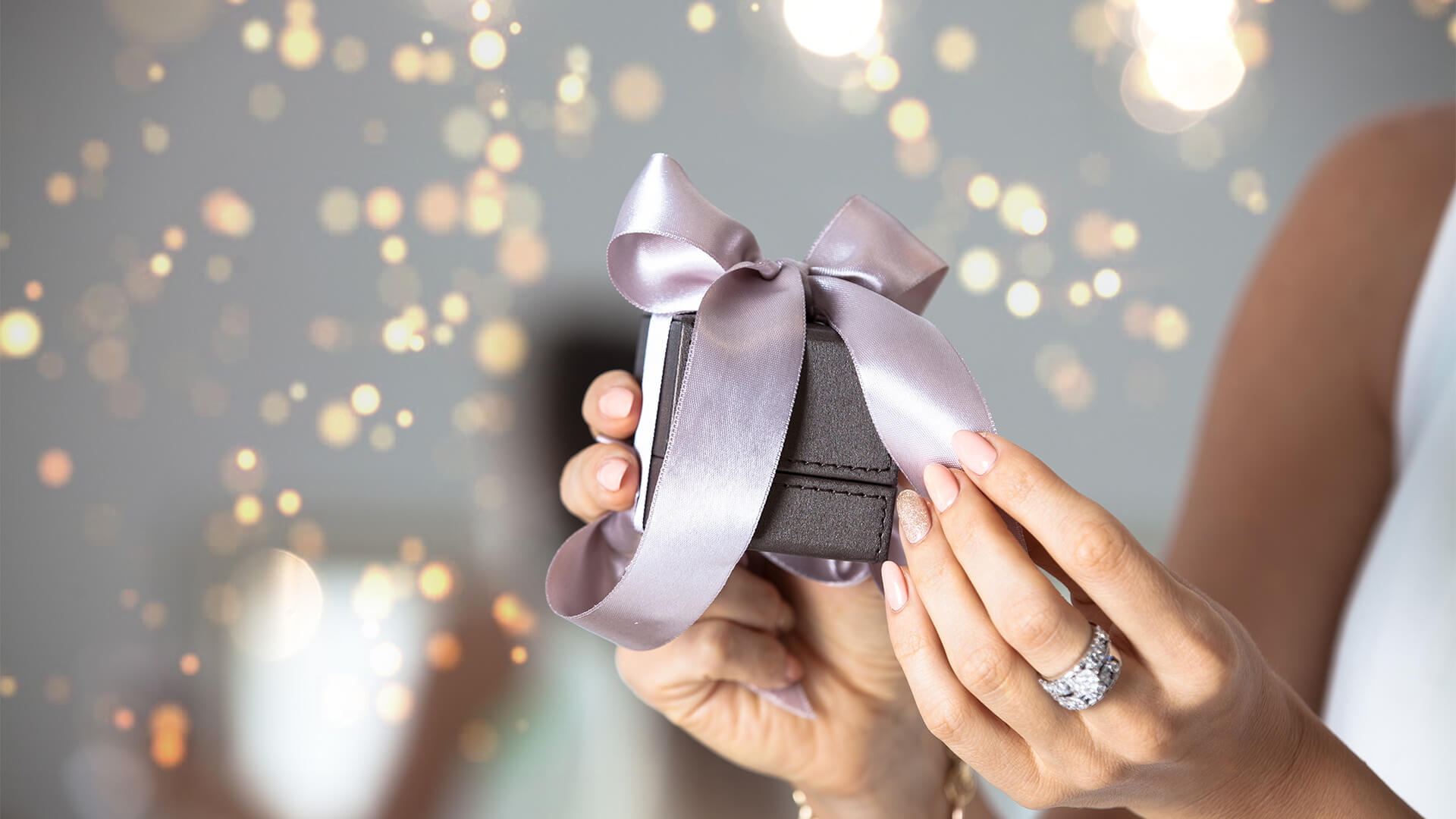 CLoseup of woman holding a gift box containing jewellery