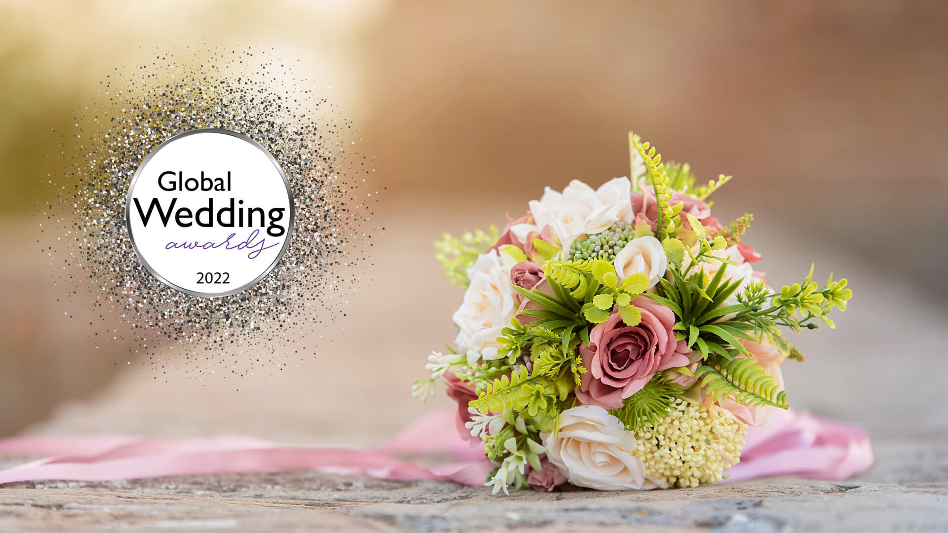 Wedding bouquet with the LUXlife Global Wedding Awards logo in the middle left