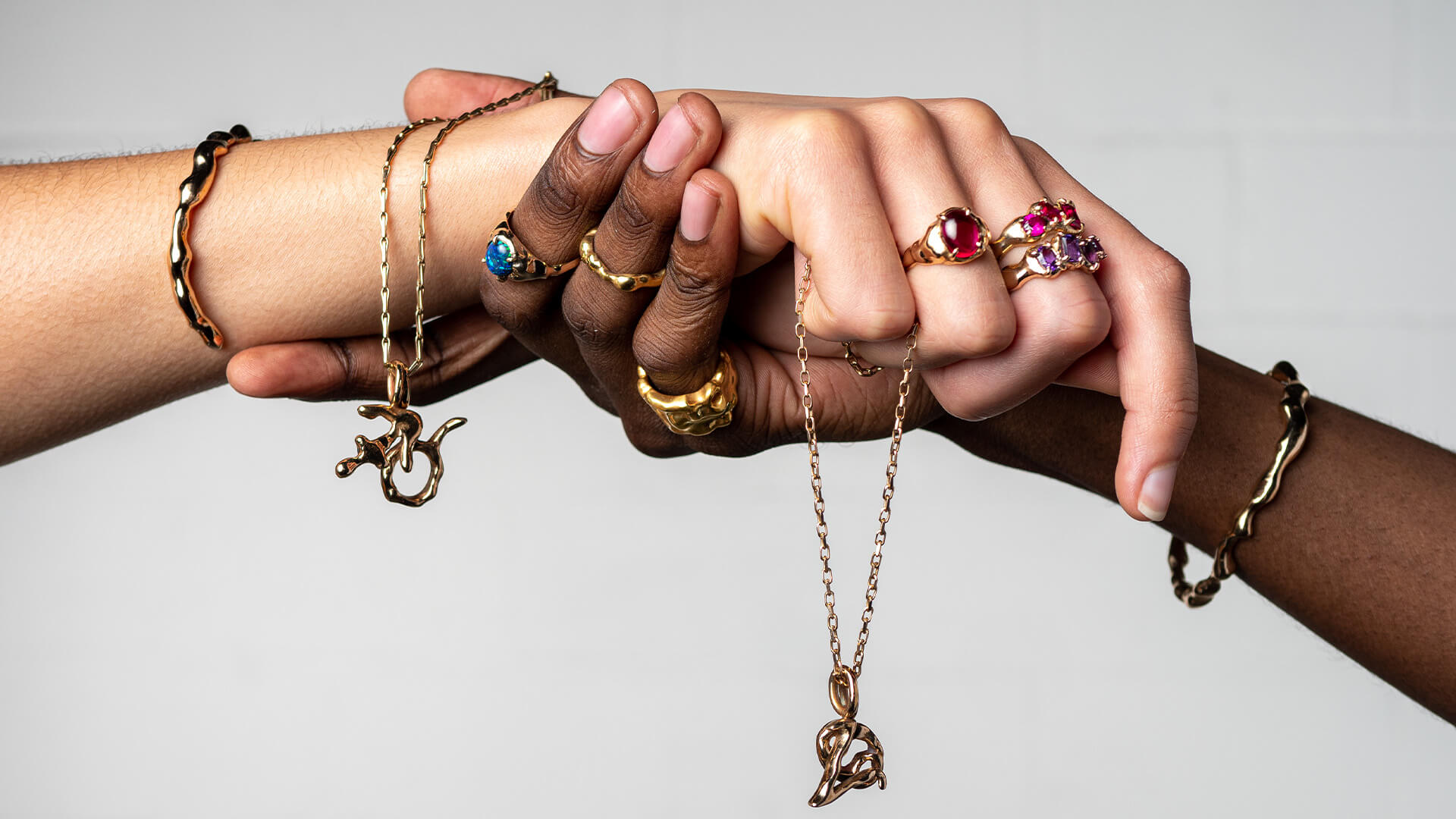 Susannah King jewellery displayed on two people holding hands