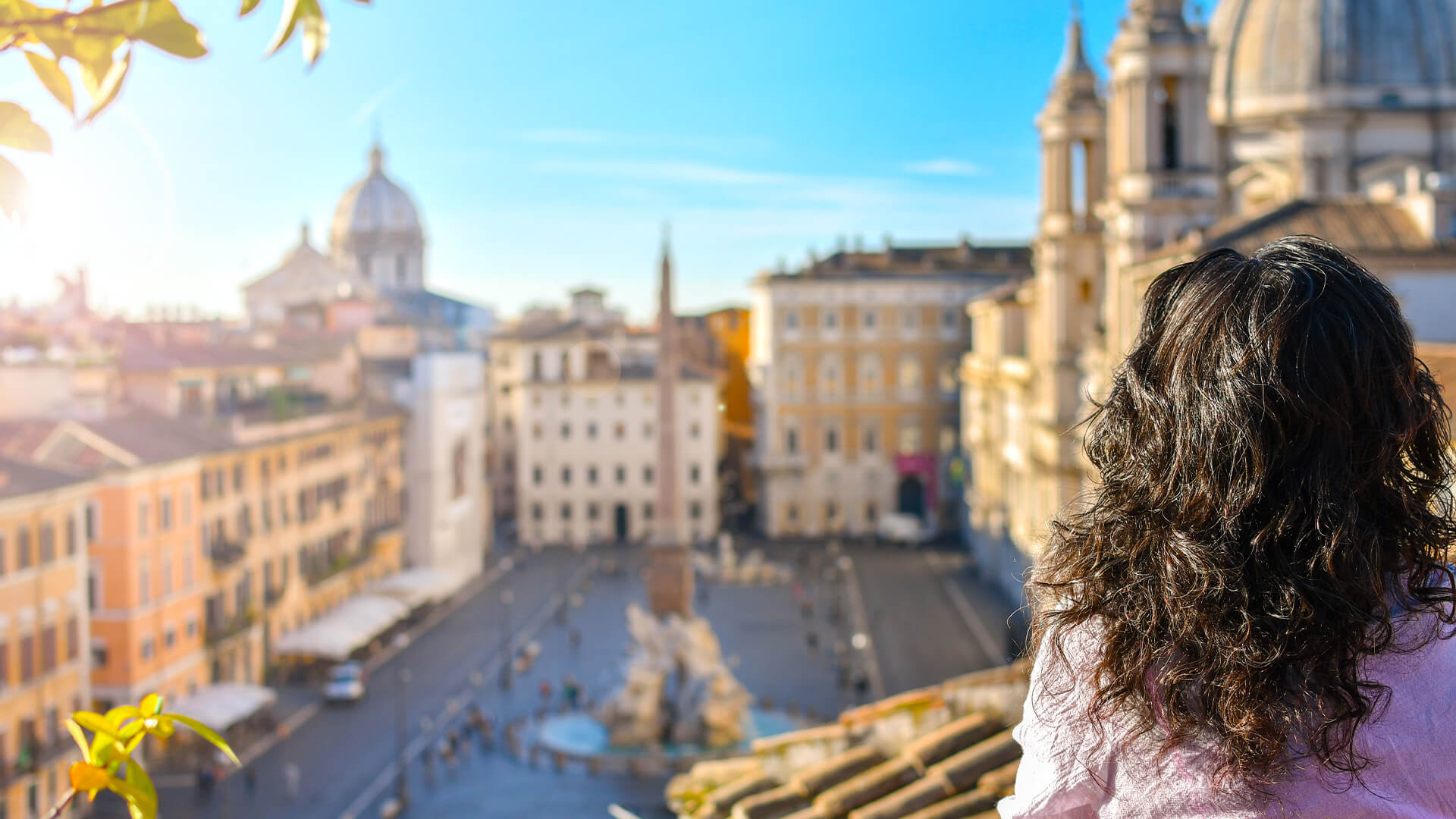 Woman standing on a rooftop overlooking the Piazza Navona in Rome, Italy