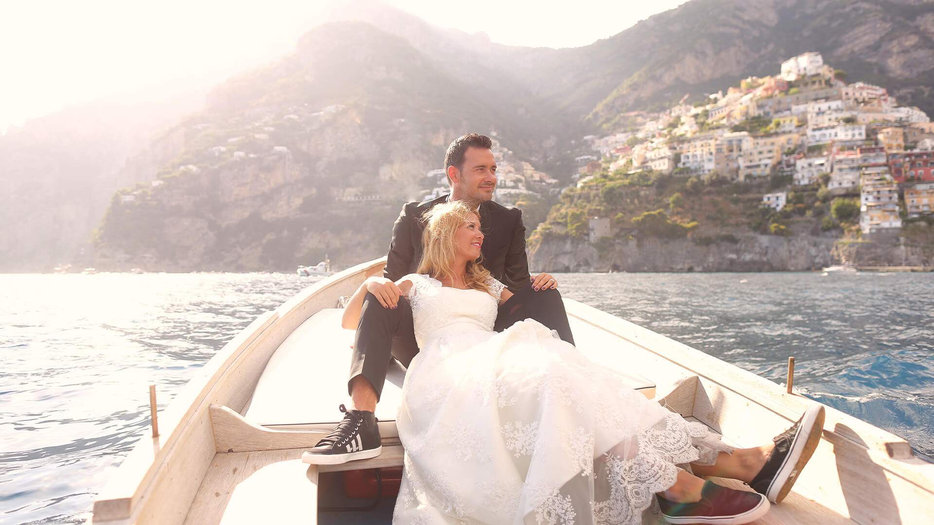 Bride and groom in a rowboat on a lake