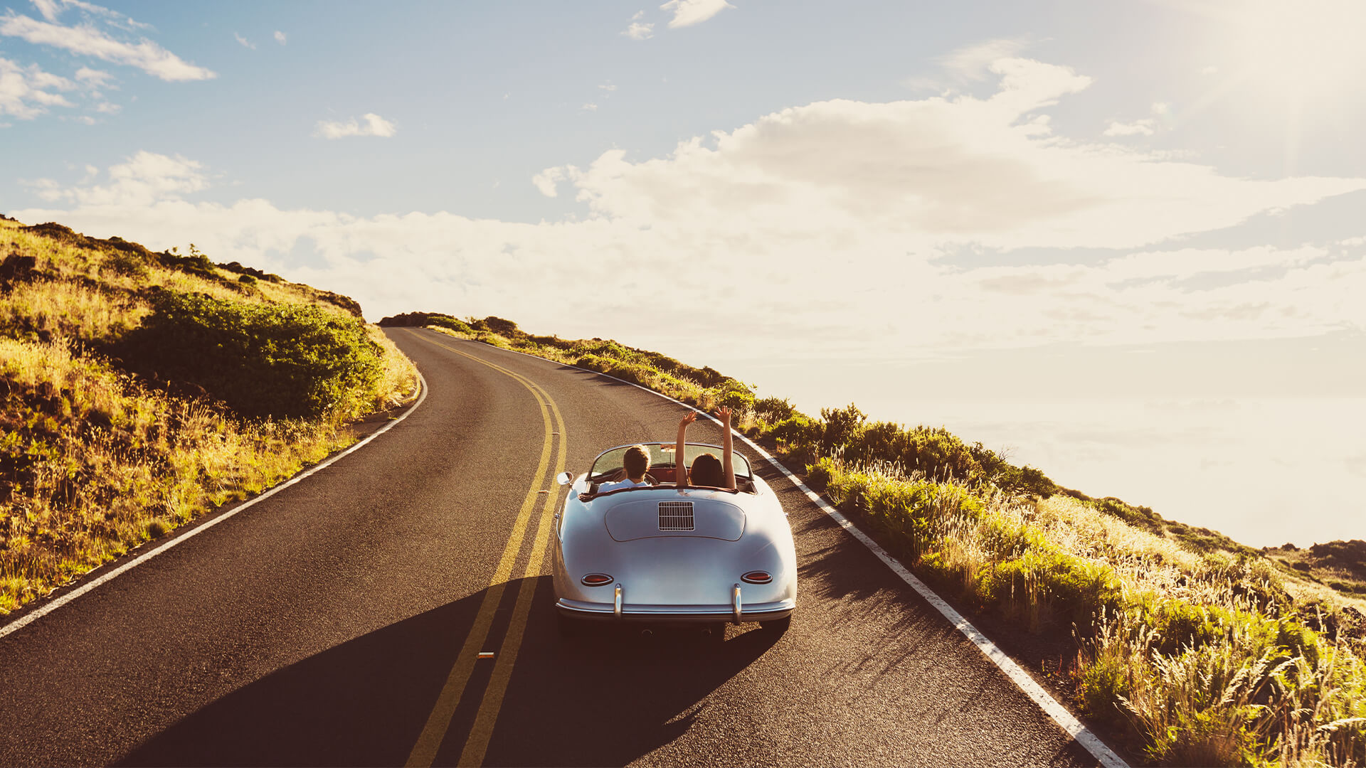 Coupe Driving on Country Road in Vintage Sports Car