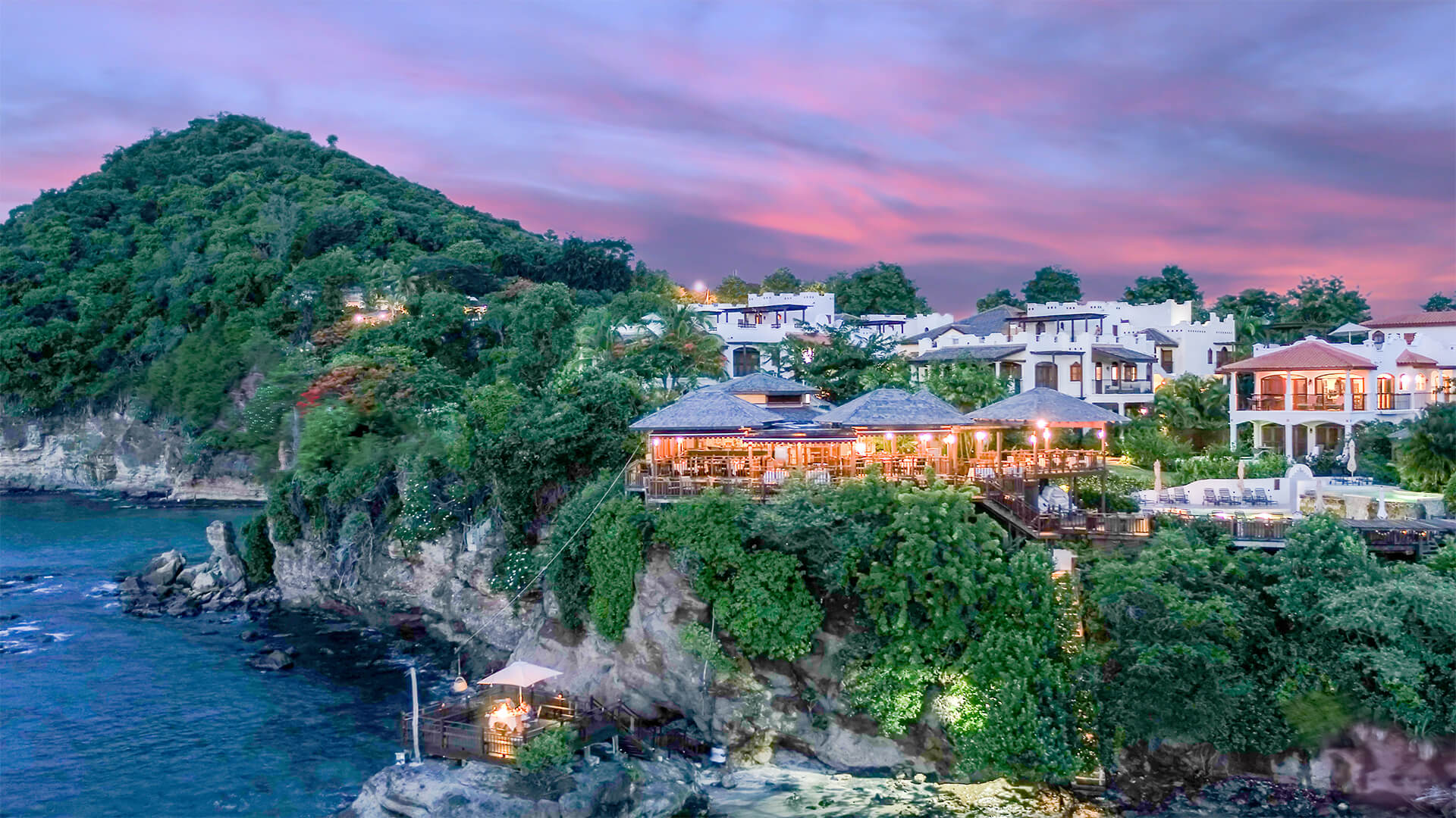 hotel on cliffside during a sunset