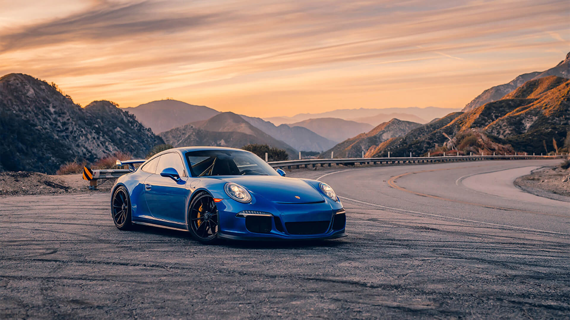 porsche on road by mountains