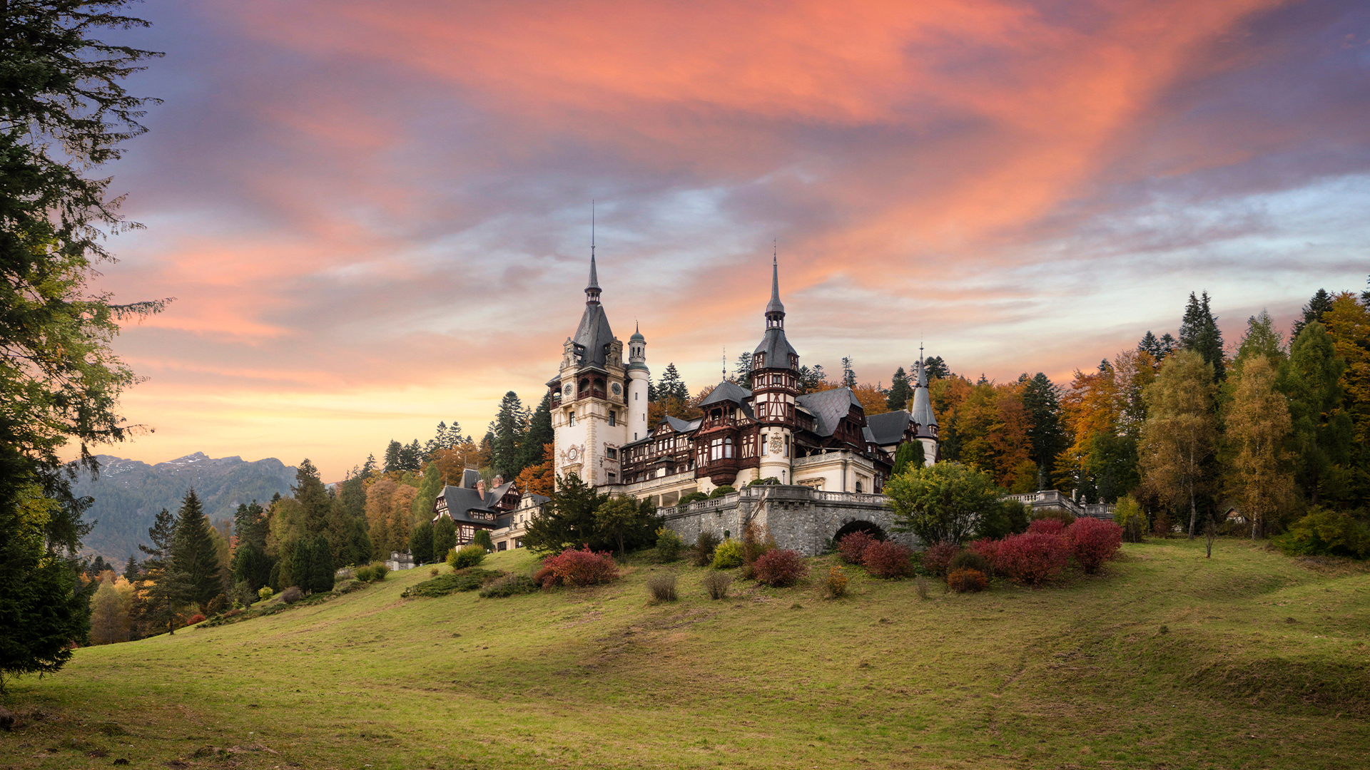 Beautiful famous royal castle and ornamental garden in Sinaia landmark of Carpathian Mountains in Europe at sunset